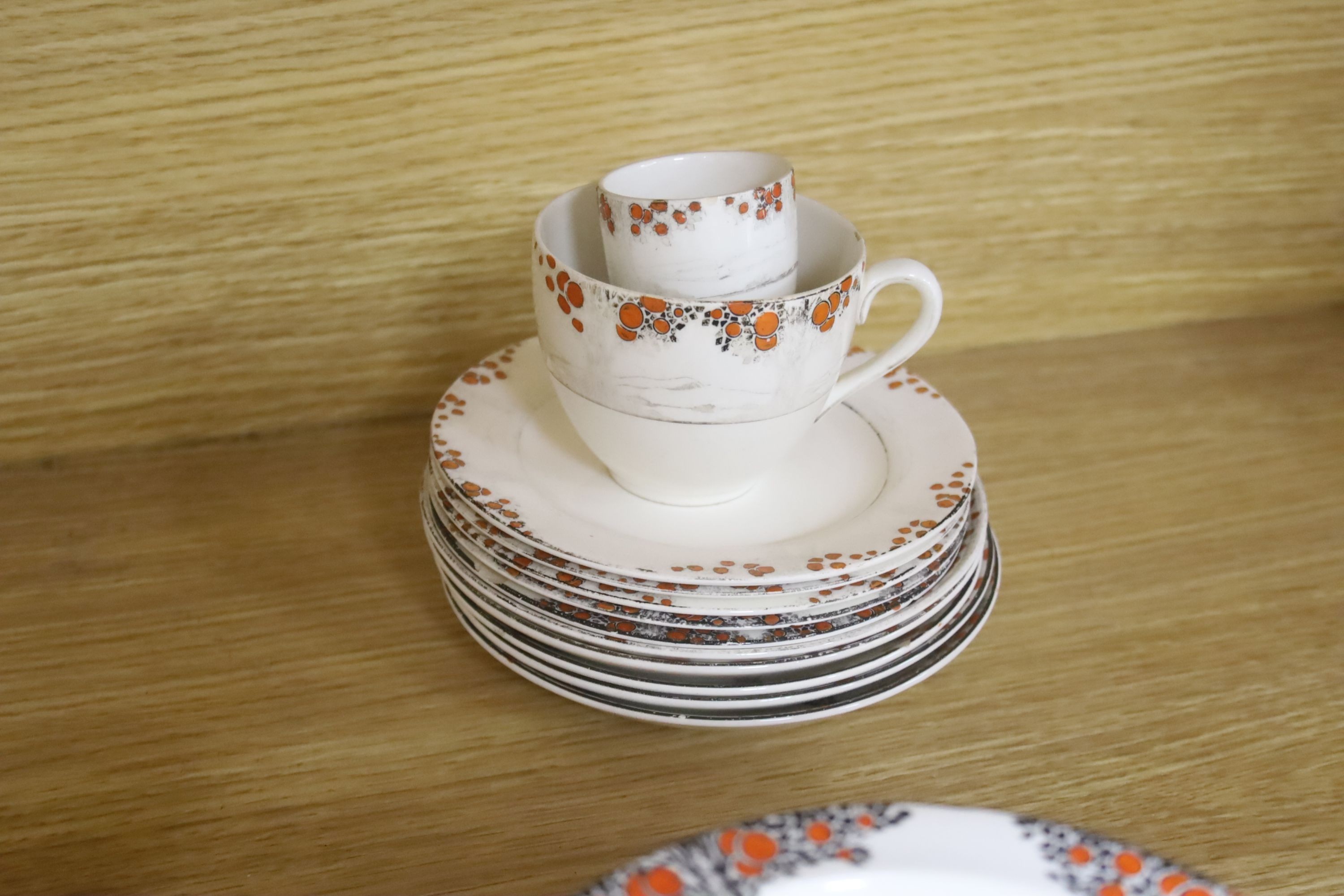 A Crown Ducal Art Deco 'Orange Tree' breakfast, tea and coffee service, to include a biscuit barrel, cheese dish and toast rack